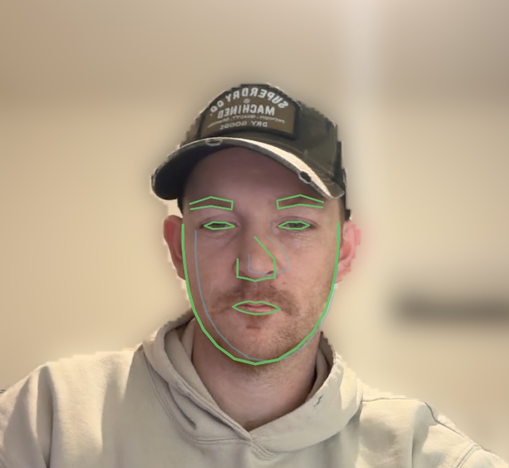 Close-up face with a green Vision-framework face-mesh overlay in Verta's live view